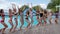 Pool party, slender girls in bathing suits jumping near swimming pool, summer life of youth on weekend,