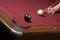 Pool player lining up billiard balls for winning shot