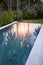 Pool with reflection of palm trees