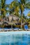 Pool, sun chairs and palm trees in an all inclusive hotel