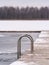 Pool swimming ladders in a hollow on a frozen lake