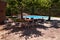 By the pool; Table and chairs in the shadow of Plane Trees