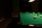 Pool Table in Empty Dimly Lit Pool Hall