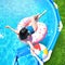 Pool time. Girl has fun in a summer metal frame pool.