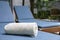 Pool towels are rolled up and placed on a sunbed by the pool in a pool villa in a luxury hotel