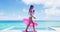 Pool vacation woman in bikini with inflatable pink flamingo pool toy float by swimming pool. Video of Girl having fun on