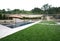 A pool with a waterfall in a luxury backyard