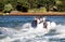 Poole, Dorset, England - June 02 2018: Two caucasian men driving fast through Poole Harbour on a rigid inflatable dinghy or RIB, o