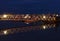 Poole Harbour at night with fishing boats moored on the pontoon, with a walkway to acce