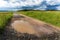 Pools of rainwater on a dirt road in the Czech countryside. Country road after the rain