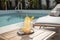 poolside lounge chair and refreshing beverage for staycation escape