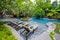 Poolside relax chairs in swimming pool