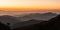 Poonhill view of mountains around Annapurnas. Warm pink and orange sunrise light over Annapurna mountain range with blue sky