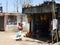 Poor Asian woman with a child near a small shop, Sri Lanka