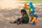 Poor child tries to sell balloons and eats food that she can find in the streets of Jaipur city.