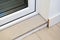 Poor decoration of the threshold of ceramic tiles. MDF skirting board is poorly installed, uneven cut. The transition between the