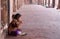 A poor girl eating in Fatehpur Sikri complex