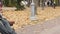 Poor homeless person sitting on bench with hungry sign, begging for spare change