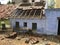 Poor indian house with broken tiles with wooden beam