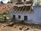 Poor indian house with broken tiles with wooden beam