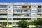 Poor looking suburban block of flats against a blue sky