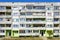 Poor looking suburban block of flats against a blue sky