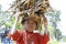 Poor malagasy boy carrying branches on his head