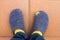 Poor man wearing worn, torn and widely used house slippers showing his toe