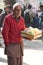 A poor old man showing emotions in his face in winter dress selling toys in a street editorial use photo.