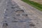 poor paved road with a lot of holes and potholes