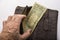Poor pensioner torn wallet with one dollar