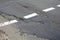 Poor quality of road repair work. Damaged asphalt road, bad road.