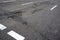 Poor quality of road repair work. Damaged asphalt road, bad road.