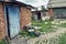 Poor rural residential courtyard with brick buildings in Ukraine. The concept of life in the Ukrainian village, a simple old