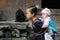 Poor traditional girl who care kid in the old village in China