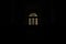 poor vintage arch shape window inside old residence hall in dark indoor environment with black background wallpaper empty space