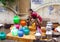 Poor young Indian woman in a sari with colorful pots near the water source