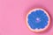 Pop Art grapefruit blue on a pink background top view