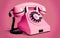 Pop art inspired retro pink telephone on pink background