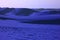 Pop art surreal style royal blue colored desert with fantastic sand ripples and sand dunes