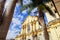 POPAYAN, COLOMBIA - FEBRUARY 06, 2018: Close up of palm trees located in the square, with a view of San Francisco church