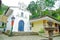 POPAYAN, COLOMBIA - FEBRUARY 06, 2018: Outdoor view of white small cathedral with a stoned fountain in Popayan town