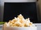 Popcorn bowl and black screen Smart TV