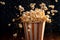 Popcorn bucket being poured with fresh popcorn, with the kernels falling into the container, creating a visually satisfying and