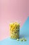 Popcorn on a colored background. Minimal food concept. Entertainment, film and video content. Aesthetics 80s and 90s concept