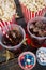 Popcorn, confectionery and drink arranged on wooden table with 4th july theme