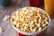 Popcorn in a cup on a wooden background. Generative AI