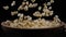 Popcorn falls into a wooden bowl