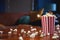 Popcorn flying out of cardboard box. red and white striped popcorn bucket with flying popcorn in the living room, movie or cinema