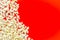 Popcorn frame on red background top view copy space